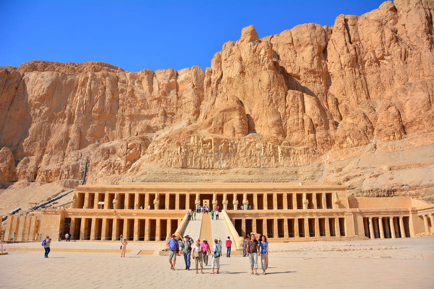 Visitors admire the facade of the Temple of Hatshepsut in Luxor